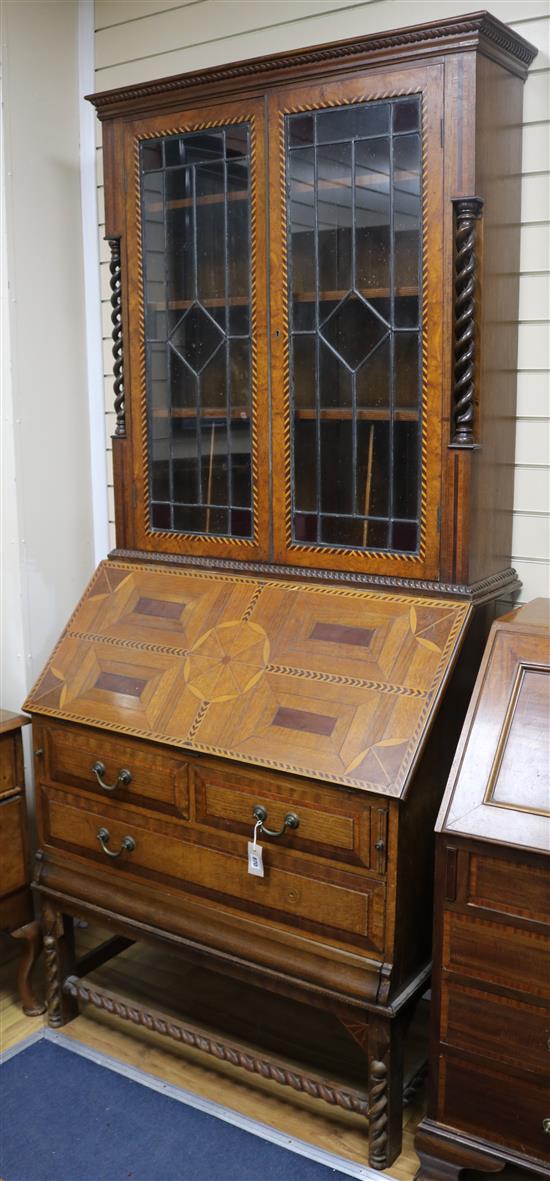 A 1920s parquetry and oak bureau bookcase W.98cm